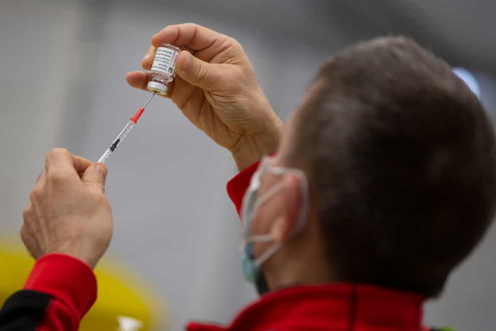 A pharmacist prepares a syringe