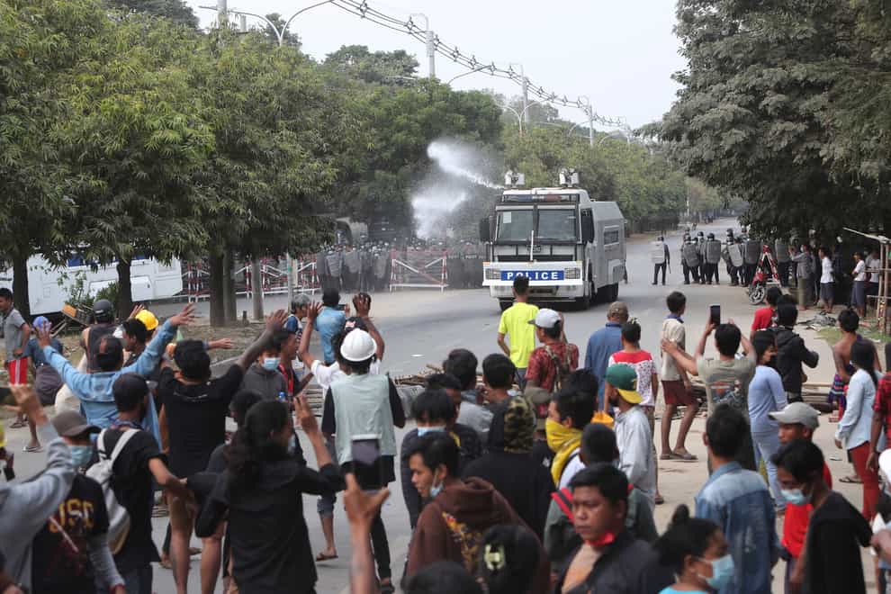 A police truck uses a water cannon to disperse protesters in Mandalay, Myanmar