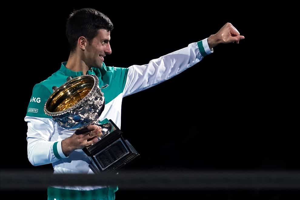 Novak Djokovic holds the Norman Brookes Challenge Cup for a ninth time