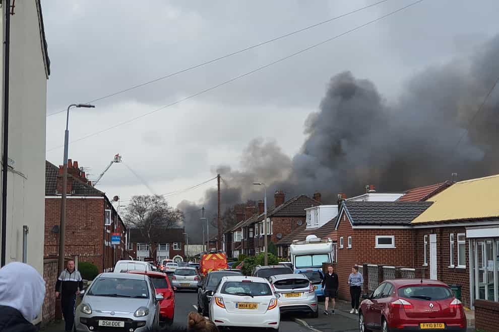 Smoke rising from a fire at a three-storey warehouse in Holland Street, Denton, Manchester