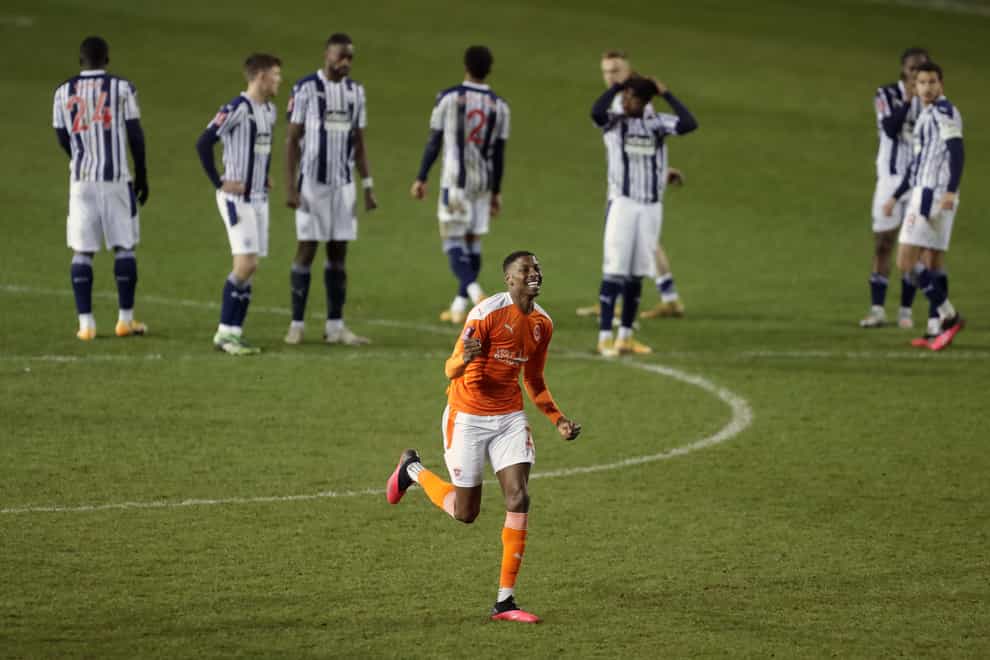 Blackpool defender Marvin Ekpiteta celebrates scoring against West Brom