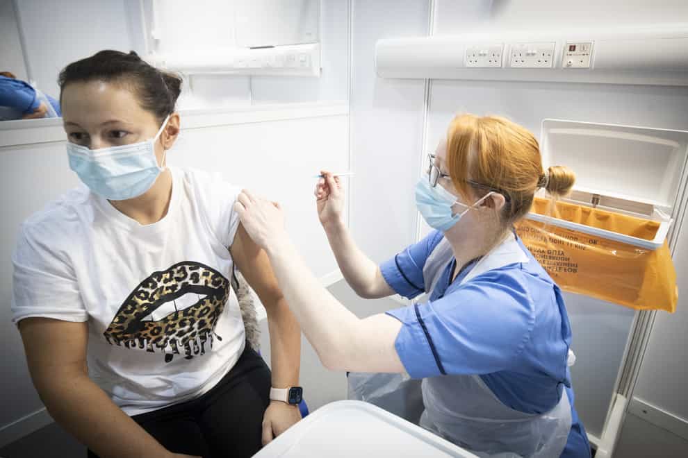 A nurse administers a Covid-19 vaccination