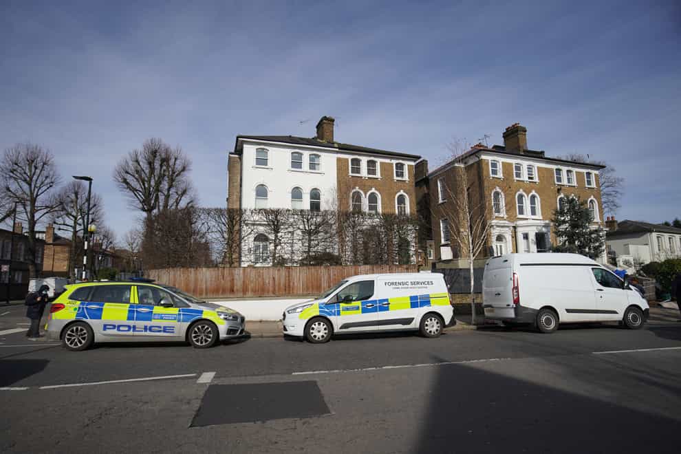 Police vehicles outside a property on Castlebar Road, Ealing, west London, where a woman in her 40s was found dead on Monday