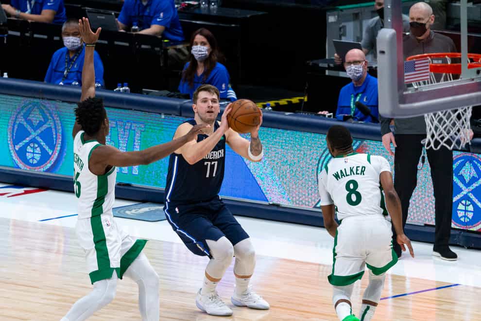 Dallas Mavericks guard Luka Doncic (77) shoots as Boston Celtics forward Aaron Nesmith (26) attempts to defend