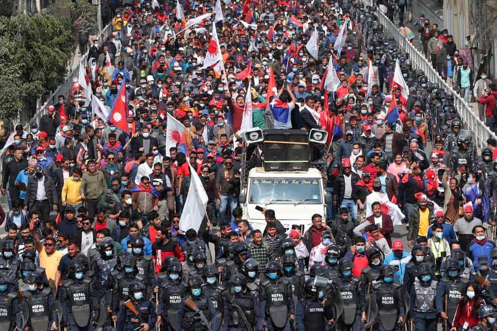 People in Nepal celebrate a court order demanding the reinstatement of Nepal's parliament