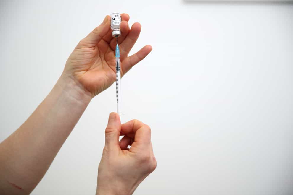 A vial of the Pfizer-BioNTech coronavirus vaccine is prepared
