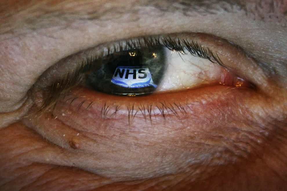 NHS logo reflected in an eye