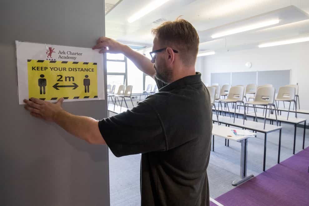 A social distancing sign is put up in a classroom at Ark Charter Academy in Portsmouth