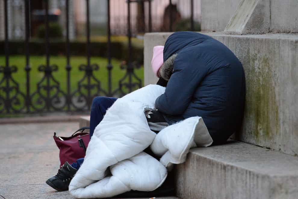 Homeless people sleep on the plinth of the Ferdinand Foch equestrian statue in Victoria, London
