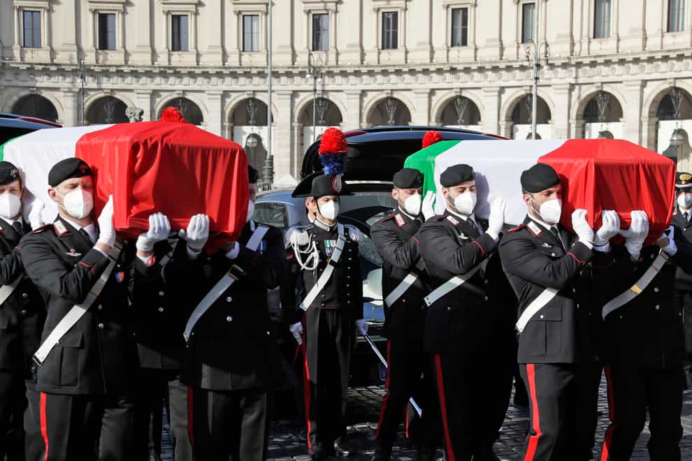 Coffins draped with the Italian flag