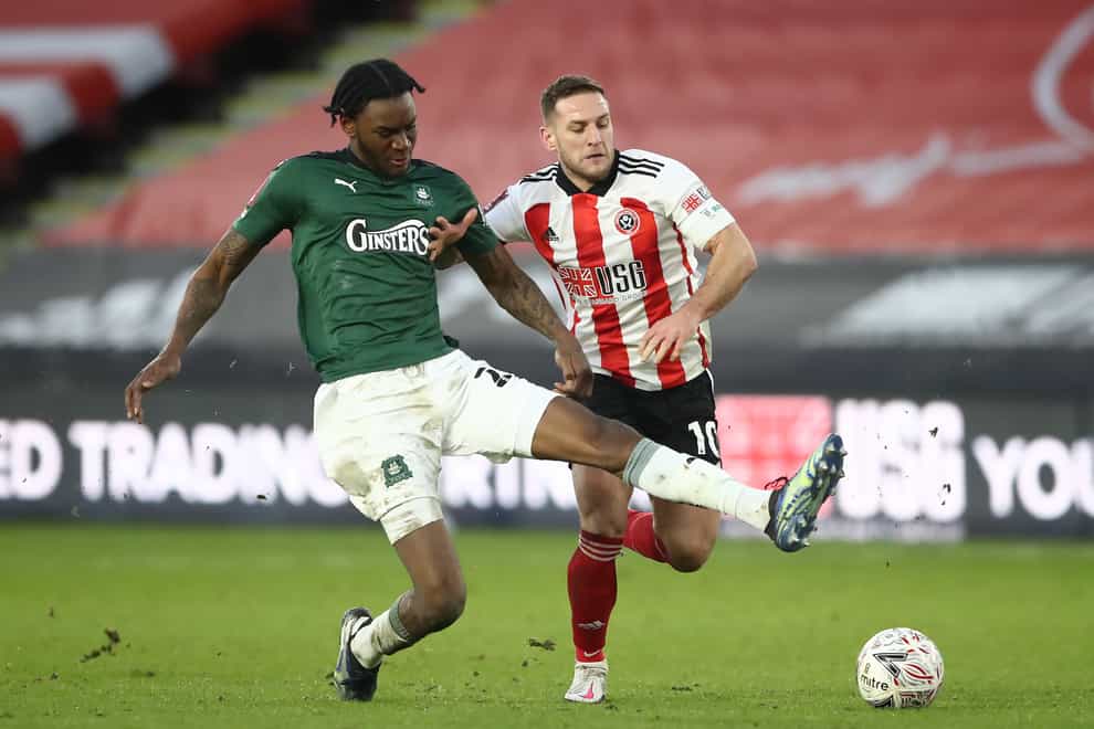 Plymouth defender Jerome Opoku (left) in action again Sheffield United