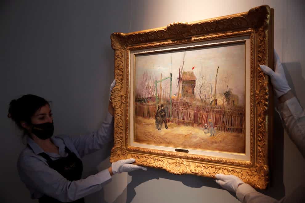 Sotheby’s personnel display the painting by Vincent van Gogh