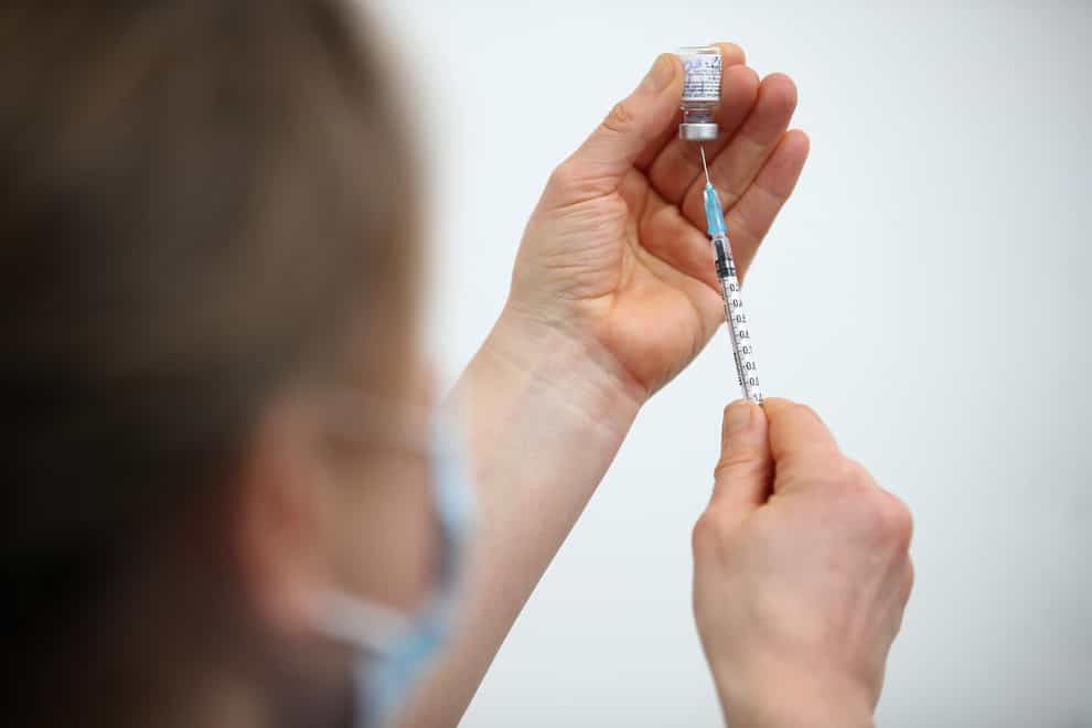 A coronavirus vaccine injection being prepared