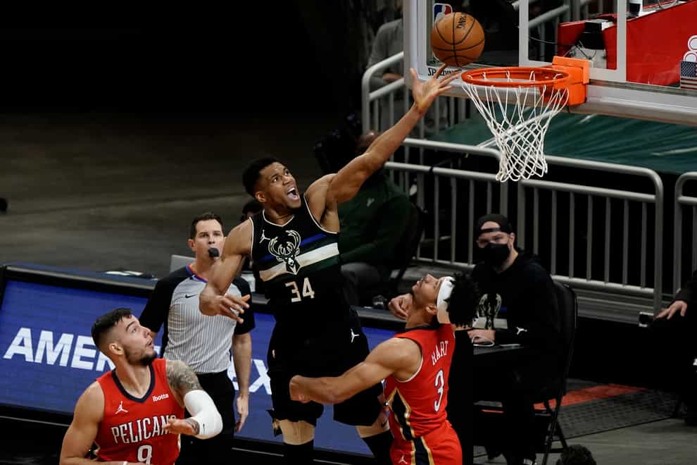 Milwaukee Bucks’ Giannis Antetokounmpo shoots over New Orleans Pelicans’ Josh Hart