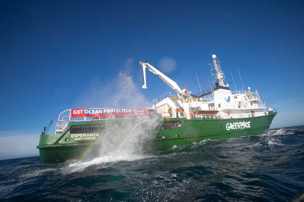 A boulder falls into the English channel from Greenpeace vessel Esperanza (Suzanne Plunkett /Greenpeace/PA)