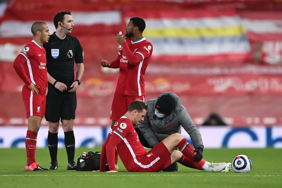 Liverpool captain Jordan Henderson is tended to by a physio