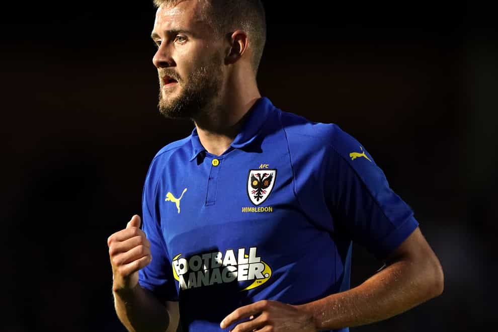 Shane McLoughlin will hope to return to the AFC Wimbledon starting line up.