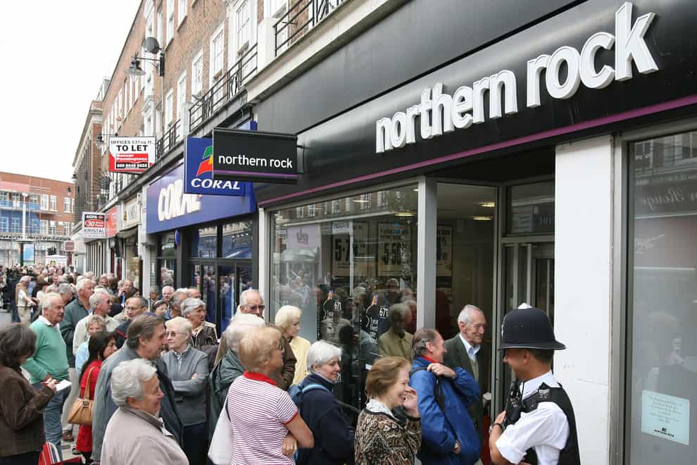 Northern Rock customers queue outside a branch