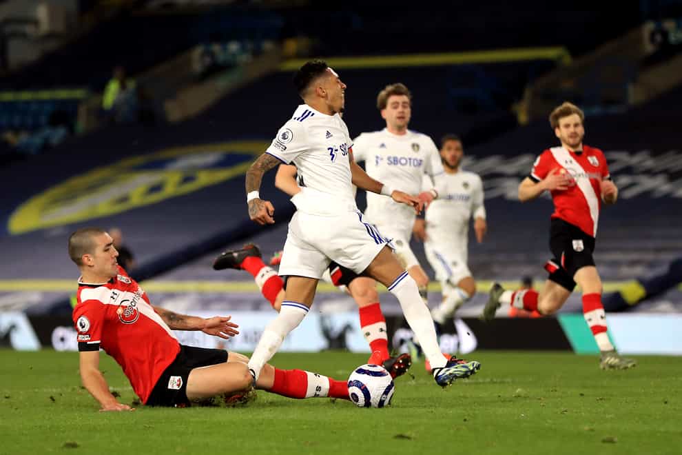 Southampton’s Oriol Romeu (left) tackles Leeds player Raphinha