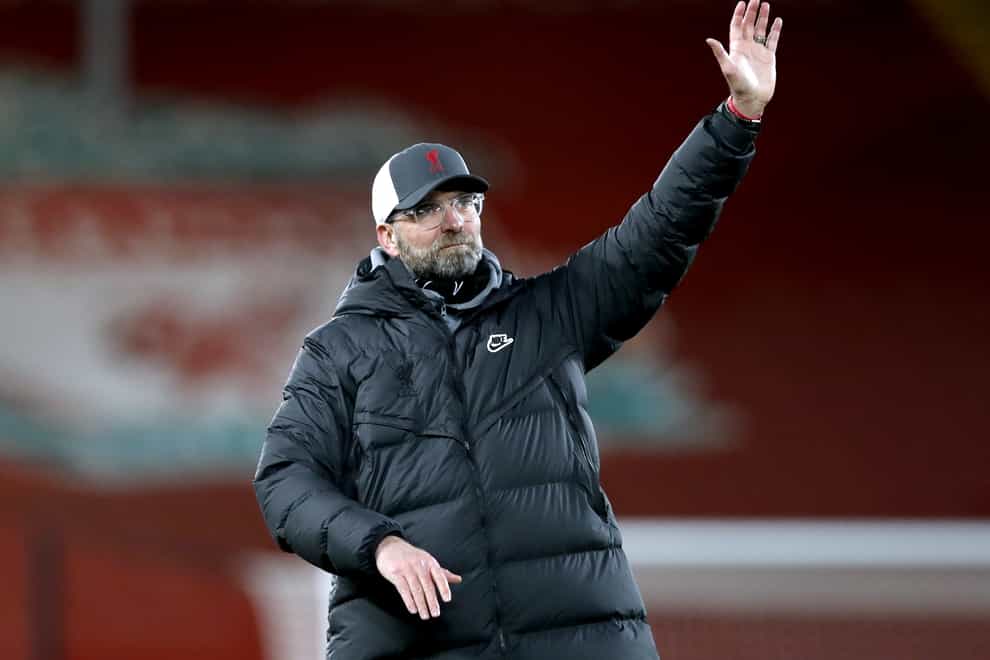Liverpool manager Jurgen Klopp raises his arm on the touchline