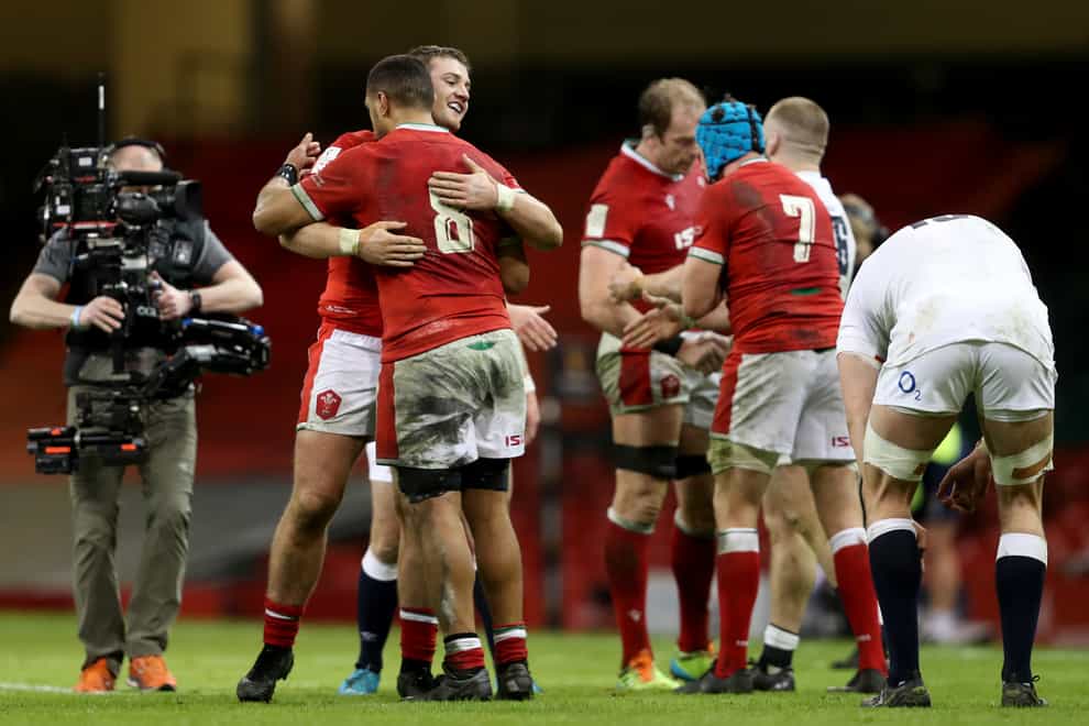 Wales’ Rhodri Jones and Taulupe Faletau (back to camera) celebrate victory over England