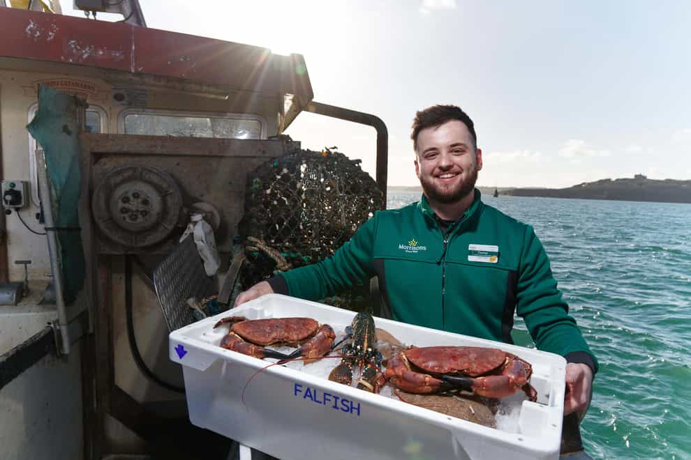 A Morrisons employee holds a tray of shellfish