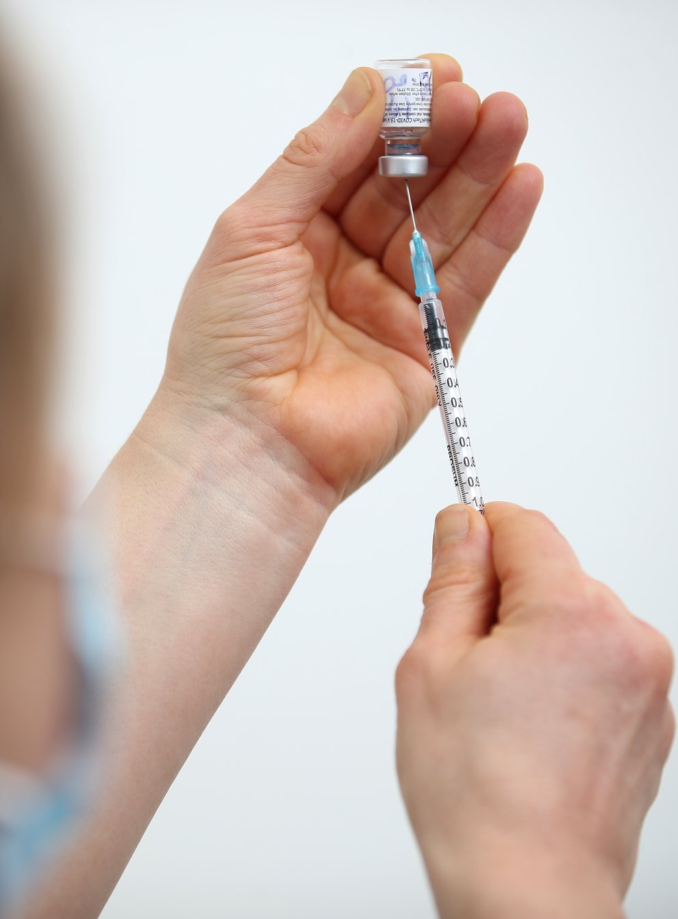 The Pfizer-BioNTech coronavirus vaccine is prepared for injection