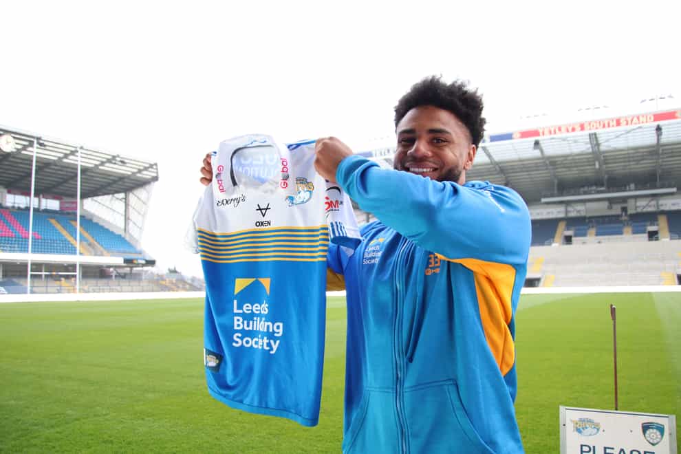 Kyle Eastmond with a Leeds Rhinos jersey following his unveiling (courtesy of Leeds Rhinos)