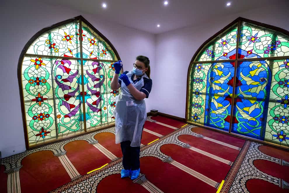 Practice nurse Hannah Currie, 25, prepares a dose of the AstraZeneca vaccine at Bradford Central Mosque, which is housing a community Covid-19 vaccination centre (Peter Byrne/PA)