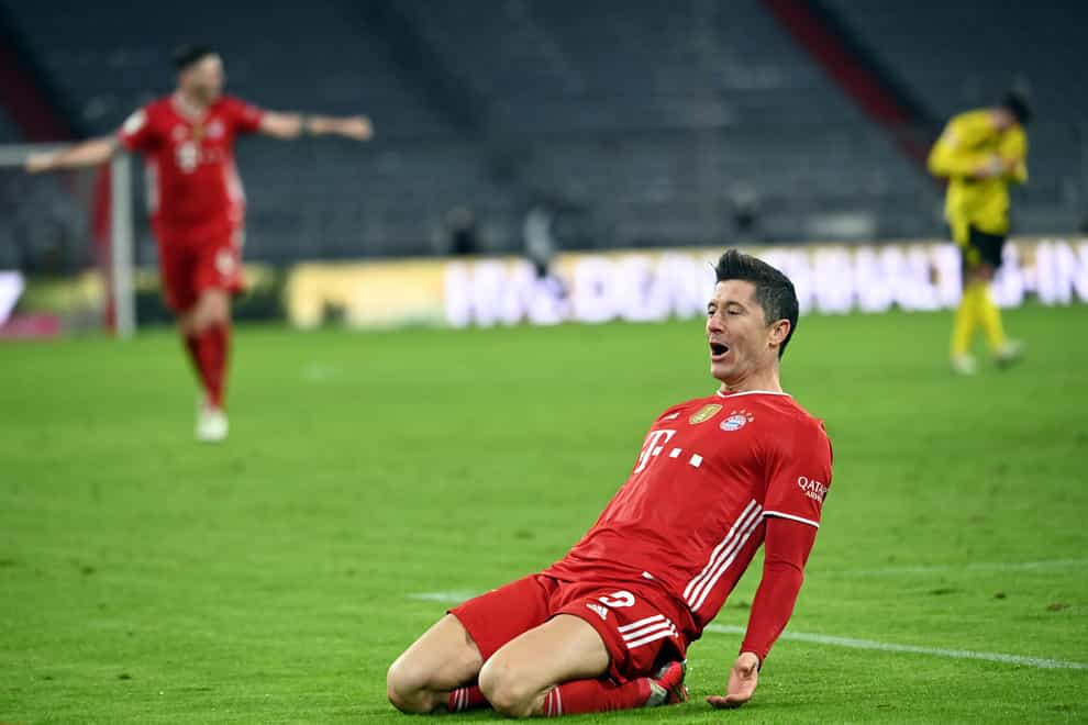 Bayern Munich forward Robert Lewandowski celebrates scoring against Borussia Dortmund