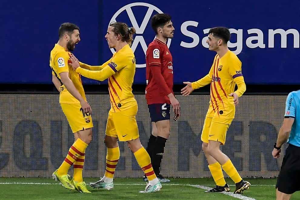 Barcelona’s Jordi Alba (left) celebrates after scoring against Osasuna