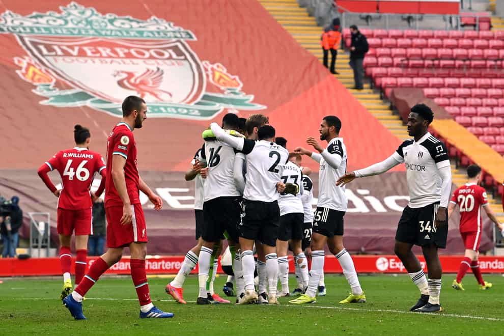 Liverpool players are dejected as Fulham celebrate