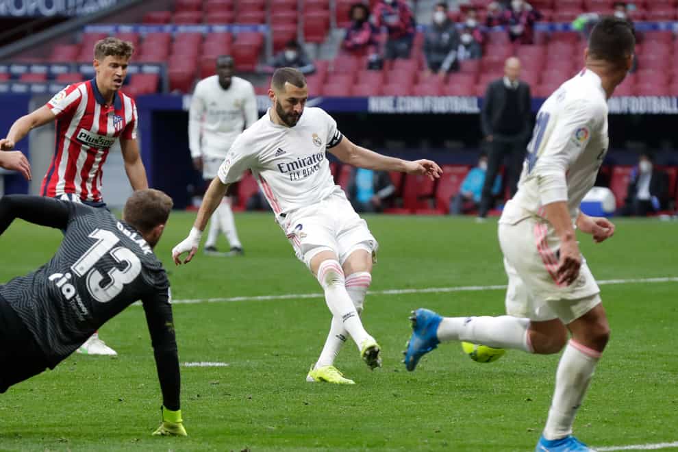 Karim Benzema, centre, helped Real Madrid claim a share of the spoils at Atletico