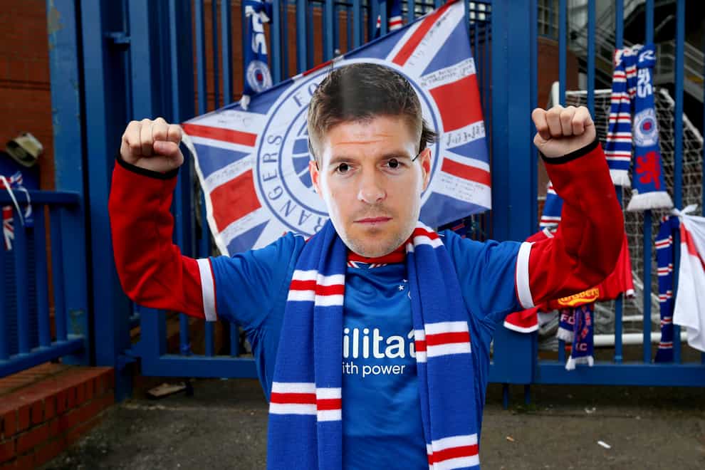 A Rangers fan wears a Steven Gerrard mask outside Ibrox