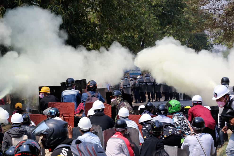 Anti-coup protesters discharge fire extinguishers to counter the impact of the tear gas fired by police during a demonstration in Naypyitaw, Myanmar