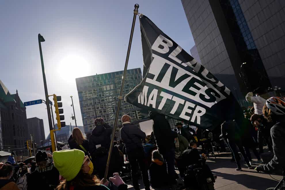 A demonstrator holds up a Black Lives Matter flag outside the Hennepin County Government Centre in Minneapolis, where the trial of former Minneapolis police officer Derek Chauvin began with jury selection