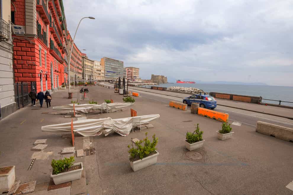A police car patrols Naples’ waterfront in Italy