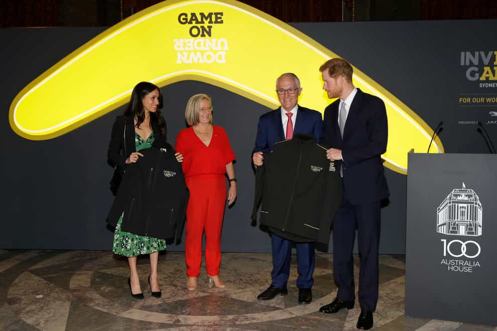 Harry and Meghan receive Invictus Games jackets from Malcolm Turnbull, then prime minister of Australia and his wife Lucy Turnbull, as they attend a reception at Australian High Commission in London, celebrating the forthcoming Invictus Games in 2018 (Alastair Grant/PA)