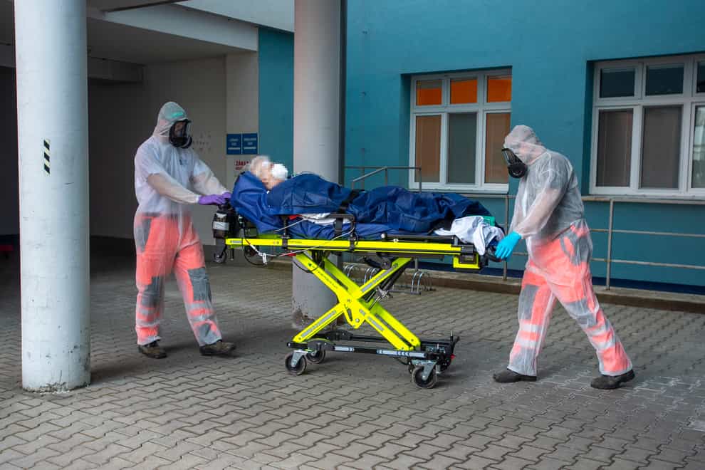 Paramedics prepare the transport of a patient with Covid-19 disease from the Usti nad Orlici Hospital, Czech Republic, to the Raciborz Hospital in Poland (Josef Vostarek/AP)