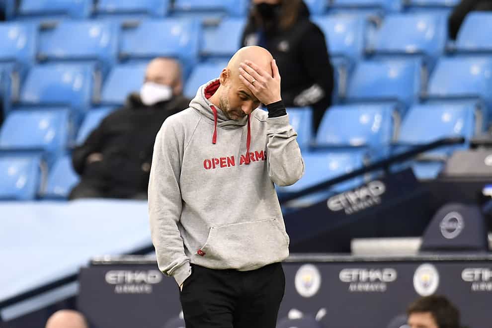 Pep Guardiola bows his head on the touchline