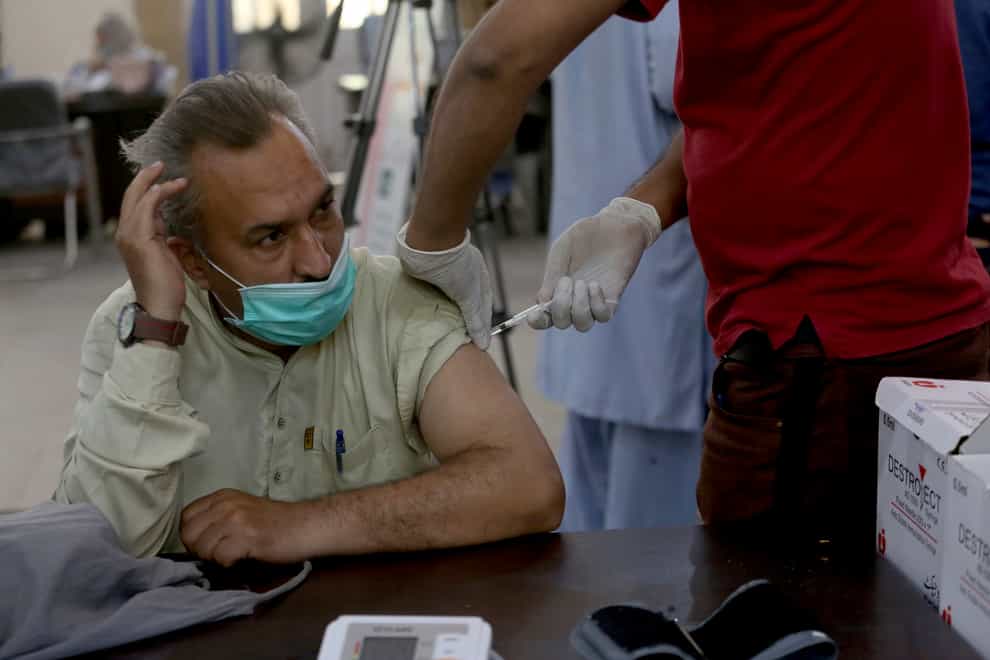 A man receives a Sinopharm coronavirus vaccine from a health worker at a vaccination centre, in Karachi, Pakistan (Fareed Khan/AP)