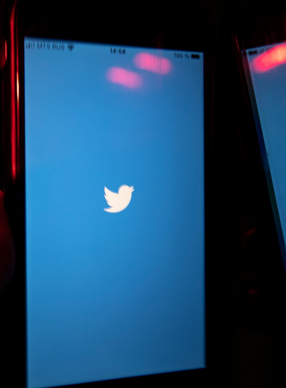 A mobile phone user turns on the Twitter application on his smartphone in Moscow, Russia (Alexander Zemlianichenko/AP)