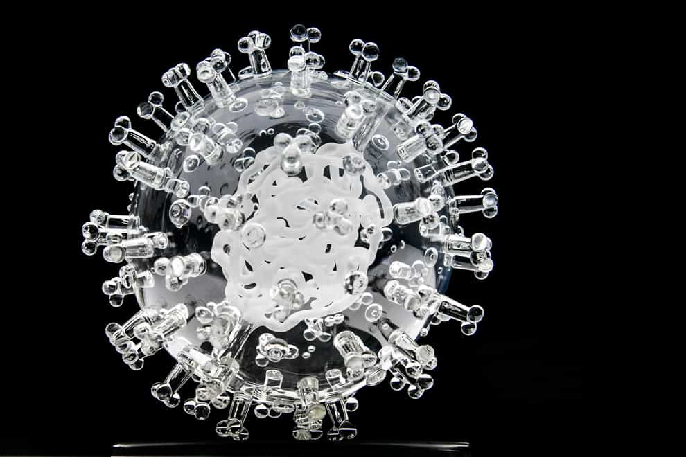 A glass sculpture of the coronavirus