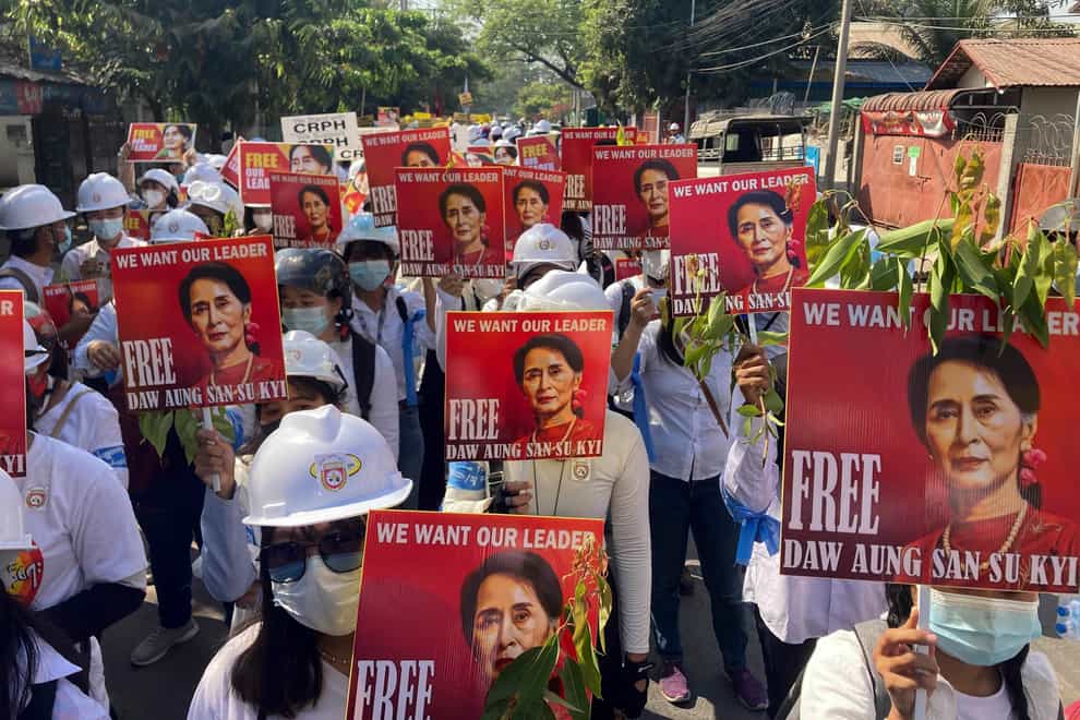 Protesters hold portraits of deposed Myanmar leader Aung San Suu Kyi during an anti-coup demonstration in Mandalay