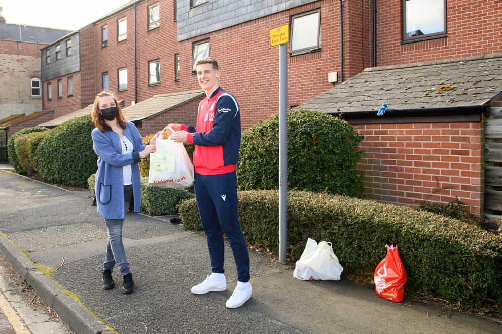 Ryan Yates of Nottingham Forest delivered the one millionth EFL food parcel to Sandie Gee – Husbands