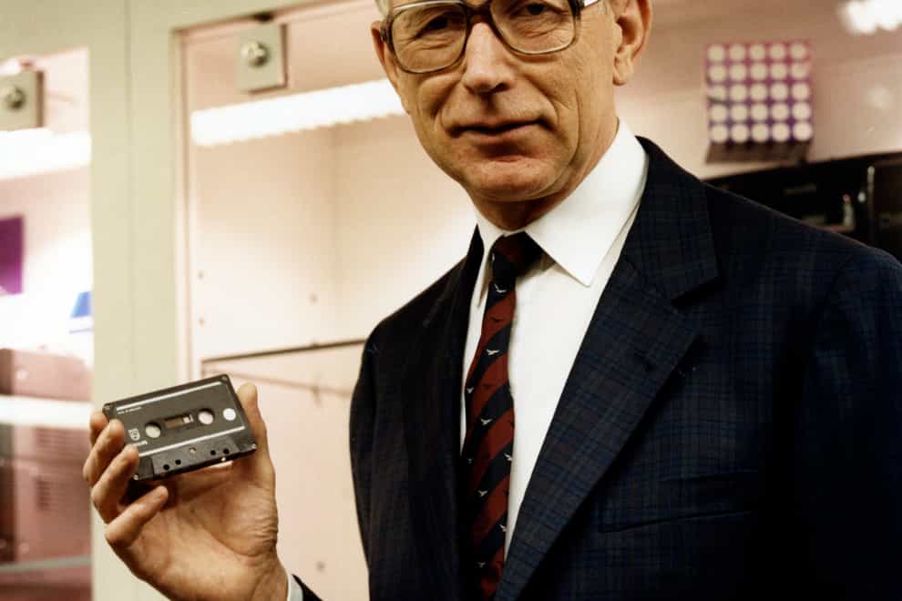 Structural engineer Lou Ottens holding an audio cassette poses for a photo in 1988 (Philips/AP)