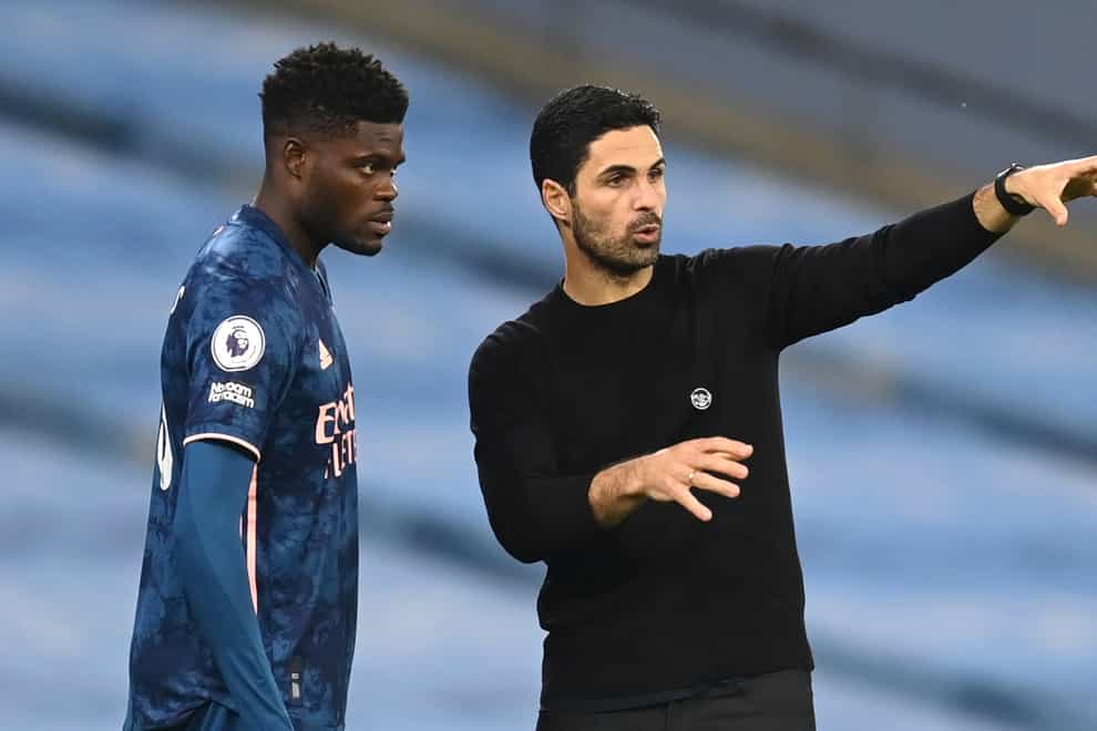 Arsenal’s Thomas Partey listens to instructions from manager Mikel Arteta