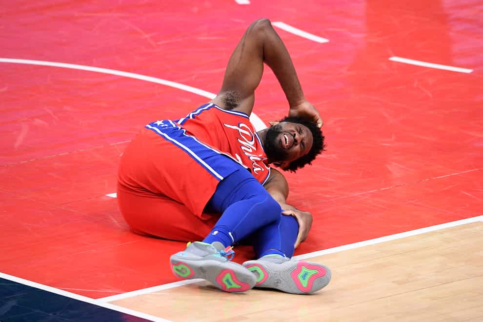 Philadelphia 76ers centre Joel Embiid reacts after an injury against the Washington Wizards