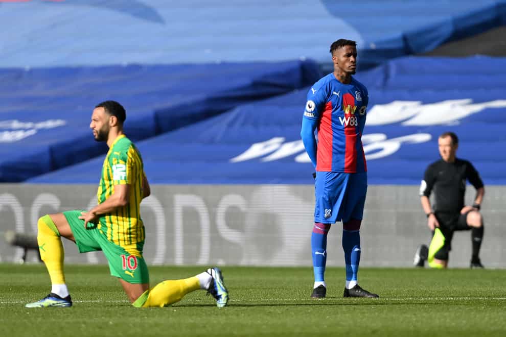 Crystal Palace’s Wilfried Zaha stands while out players take a knee prior to the Premier League match with West Brom at Selhurst Park