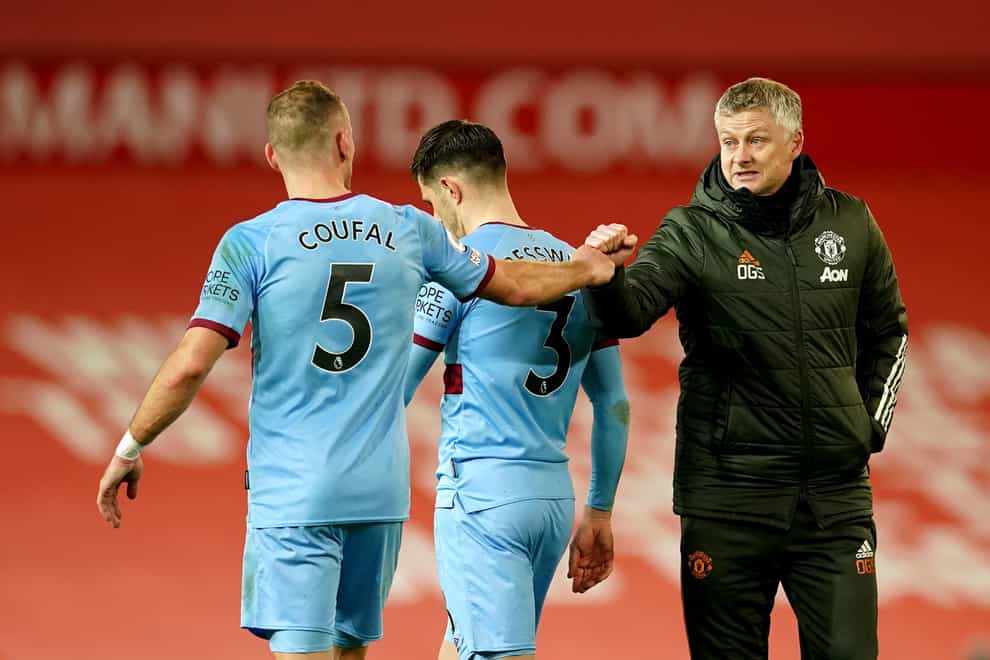 Ole Gunnar Solskjaer, right, bumps fists with West Ham's Vladimir Coufal after the game